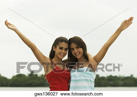 Portrait of two teenage girls with their arms around each other View Large Photo Image Stock Photo - Portrait of two teenage girls with their arms around each other. Fotosearch