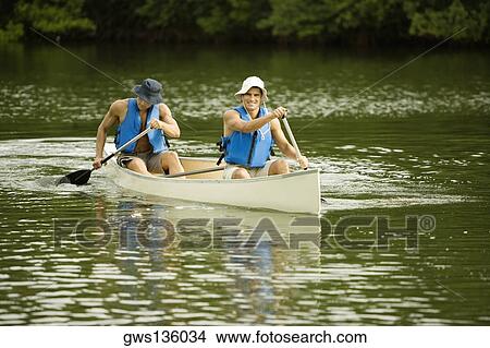 Two mid adult men boating in a lake View Large Photo Image Picture - Two mid adult men boating in a lake. Fotosearch