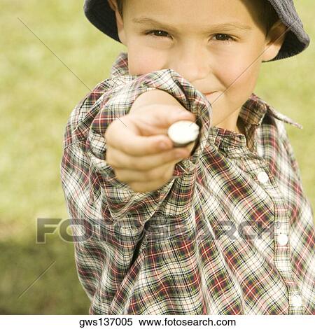 Close-up of a boy holding a candy View Large Photo Image Stock Photography - Close-up of a boy holding a candy. Fotosearch