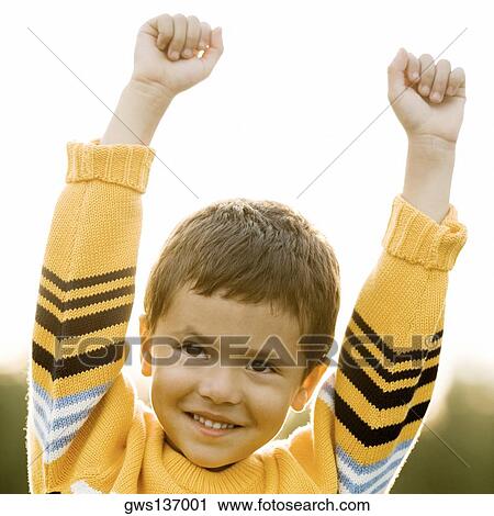 Close-up of a boy standing with his hands raised View Large Photo Image Stock Image - Close-up of a boy standing with his hands raised. Fotosearch