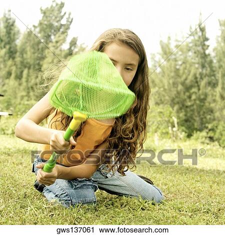 Close-up of a girl sitting holding a butterfly net View Large Photo Image Stock Image - Close-up of a girl sitting holding a butterfly net. Fotosearch