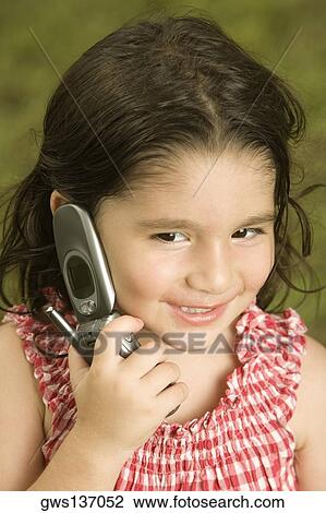 Close-up of a girl talking on a mobile phone View Large Photo Image Stock Image - Close-up of a girl talking on a mobile phone. Fotosearch