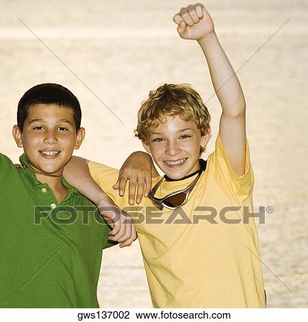 Stock Image - Portrait of a boy and a teenage boy smiling. Fotosearch