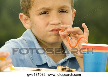 Portrait of a boy drinking through straw View Large Photo Image Stock Photograph - Portrait of a boy drinking through straw. Fotosearch