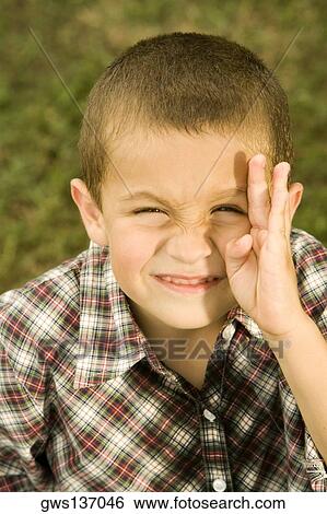 Portrait of a boy making a face View Large Photo Image Stock Photograph - Portrait of a boy making a face. Fotosearch
