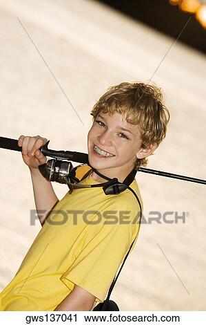 Portrait of a boy smiling carrying a fishing rod View Large Photo Image Stock Image - Portrait of a boy smiling carrying a fishing rod. Fotosearch