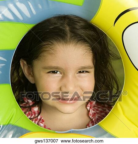 Portrait of a girl looking through an inflatable ring View Large Photo Image Stock Photo - Portrait of a girl looking through an inflatable ring. Fotosearch