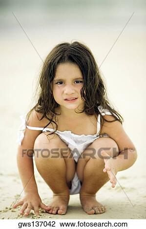 Portrait of a girl playing with sand on the beach View Large Photo Image Stock Image - Portrait of a girl playing with sand on the beach. Fotosearch
