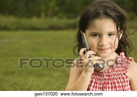 Stock Image - Portrait of a girl talking on a mobile phone. Fotosearch