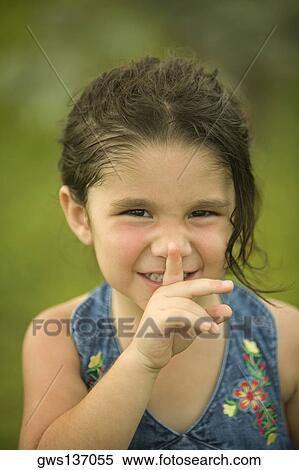 Portrait of a girl with her finger on her lips View Large Photo Image Stock Photography - Portrait of a girl with her finger on her lips. Fotosearch