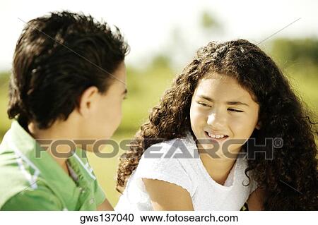 Side profile of a brother and his sister talking View Large Photo Image Stock Image - Side profile of a brother and his sister talking. Fotosearch