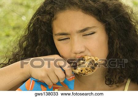 Close-up of a girl eating a chicken drumstick View Large Photo Image Stock Image - Close-up of a girl eating a chicken drumstick. Fotosearch