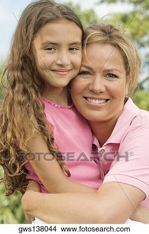 Close-up of a mother hugging her daughter View Large Photo Image Picture - Close-up of a mother hugging her daughter. Fotosearch