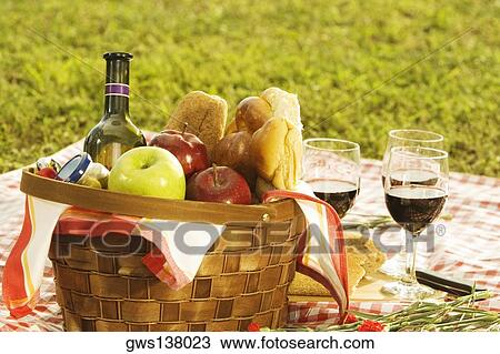 Close-up of a wine bottle with bread and fruits in a picnic basket View Large Photo Image Stock Image - Close-up of a wine bottle with bread and fruits in a picnic basket. Fotosearch