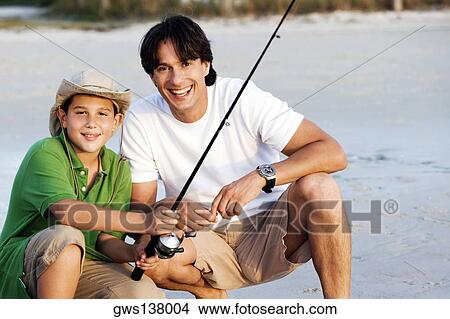 Portrait of a father and his son fishing on the beach View Large Photo Image Picture - Portrait of a father and his son fishing on the beach. Fotosearch