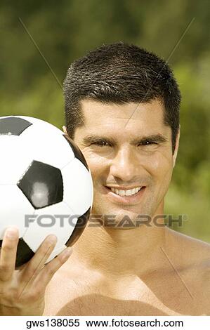 Portrait of a mid adult man holding a soccer ball View Large Photo Image Stock Photography - Portrait of a mid adult man holding a soccer ball. Fotosearch