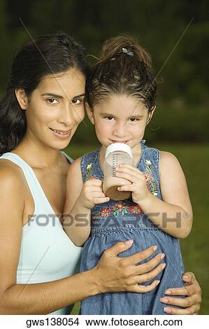 Portrait of a mother holding her daughter View Large Photo Image Picture - Portrait of a mother holding her daughter. Fotosearch