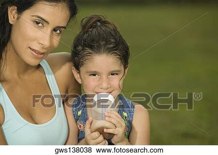 Portrait of a mother holding her daughter View Large Photo Image Stock Photo - Portrait of a mother holding her daughter. Fotosearch