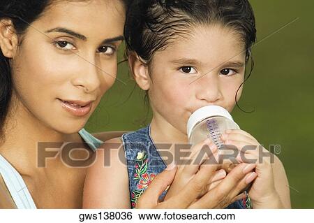 Stock Photograph - Portrait of a mother holding her daughter. Fotosearch