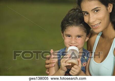 Portrait of a mother holding her daughter View Large Photo Image Stock Photography - Portrait of a mother holding her daughter. Fotosearch