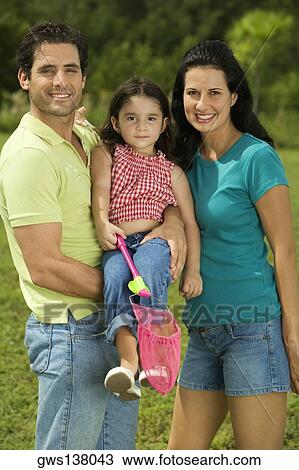 Portrait of parents and their daughter smiling View Large Photo Image Stock Image - Portrait of parents and their daughter smiling. Fotosearch