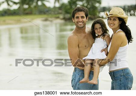 Portrait of parents carrying their daughter on the beach View Large Photo Image Stock Image - Portrait of parents carrying their daughter on the beach. Fotosearch