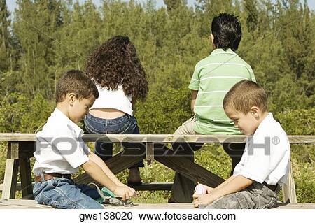 Side profile of two boys playing with toys View Large Photo Image Stock Image - Side profile of two boys playing with toys. Fotosearch