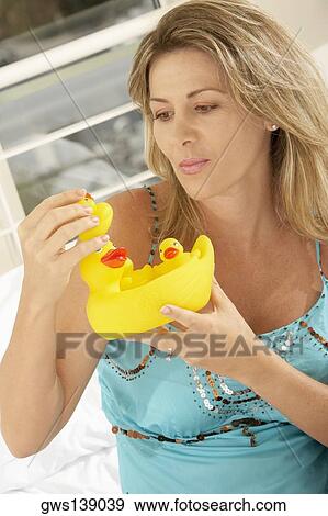 Close-up of a mid adult woman holding rubber ducks View Large Photo Image Stock Photo - Close-up of a mid adult woman holding rubber ducks. Fotosearch