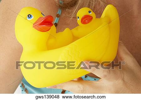 Close-up of a mid adult woman holding rubber ducks View Large Photo Image Stock Photo - Close-up of a mid adult woman holding rubber ducks. Fotosearch