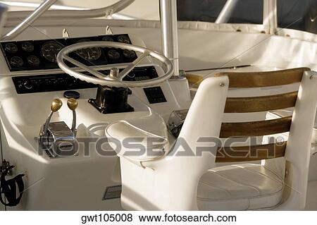 Close-up of the steering wheel of a boat View Large Photo Image Stock Photo - Close-up of the steering wheel of a boat. Fotosearch