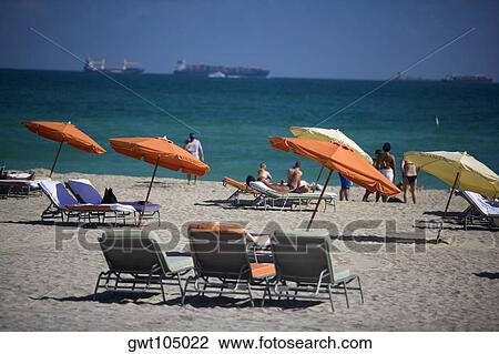 Group of people sunbathing on the beach, Miami, Florida, USA View Large Photo Image Stock Image - Group of people sunbathing on the beach, Miami, Florida, USA. Fotosearch