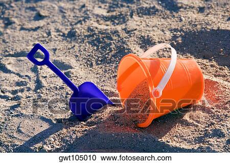 Stock Image - High angle view of a sand pail and a shovel on the beach, Miami, Florida, USA. Fotosearch