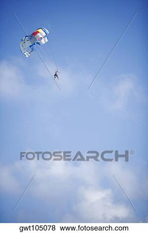 Stock Photo - Low angle view of a person parasailing, Miami, Florida, USA. Fotosearch