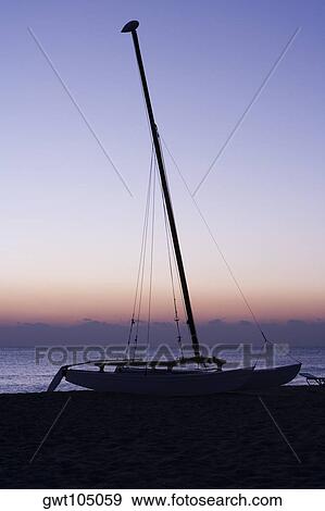 Silhouette of a sailboat on the beach, Miami, Florida, USA View Large Photo Image Stock Photo - Silhouette of a sailboat on the beach, Miami, Florida, USA. Fotosearch
