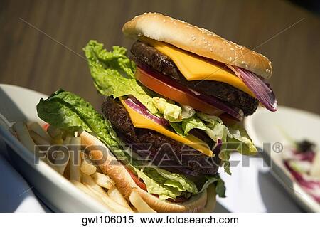 Close-up of a hamburger and French fries View Large Photo Image Stock Photography - Close-up of a hamburger and French fries. Fotosearch