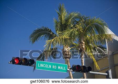 Stock Photograph - Low angle view of an information board on a traffic light, Miami, Florida, USA. Fotosearch