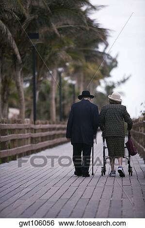 Senior couple walking on a walkway, Miami, Florida, USA View Large Photo Image Stock Photograph - Senior couple walking on a walkway, Miami, Florida, USA. Fotosearch