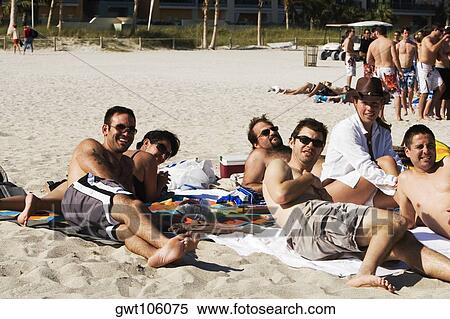 Young men and two young women sunbathing on the beach, South Beach, Miami, Florida, USA View Large Photo Image Stock Photography - Young men and two young women sunbathing on the beach, South Beach, Miami, Florida, USA. Fotosearch