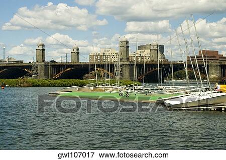 Sail boats anchored in the river near an arch bridge, Boston, Massachusetts, USA View Large Photo Image Stock Photo - Sail boats anchored in the river near an arch bridge, Boston, Massachusetts, USA. Fotosearch