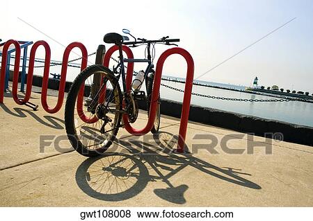 Bicycle parked at a bicycle rack, Lake Michigan, Chicago, Illinois, USA View Large Photo Image Stock Photo - Bicycle parked at a bicycle rack, Lake Michigan, Chicago, Illinois, USA. Fotosearch
