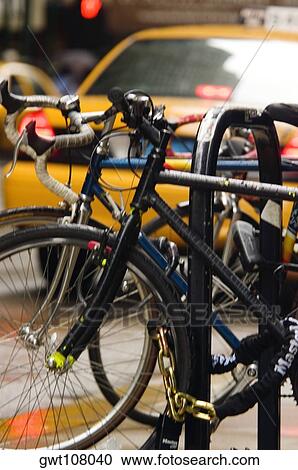 Stock Image - Close-up of bicycles parked at a bike rack, Chicago, Illinois, USA. Fotosearch