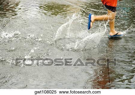 Low section view of a boy splashing water View Large Photo Image Stock Photography - Low section view of a boy splashing water. Fotosearch