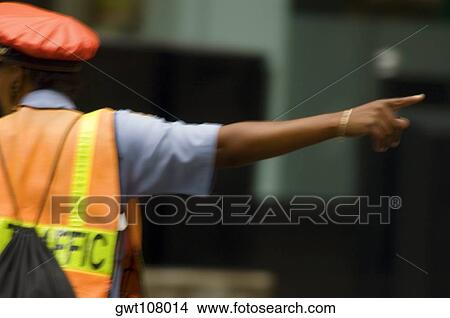 Rear view of a traffic cop directing traffic, Chicago, Illinois, USA View Large Photo Image Picture - Rear view of a traffic cop directing traffic, Chicago, Illinois, USA. Fotosearch