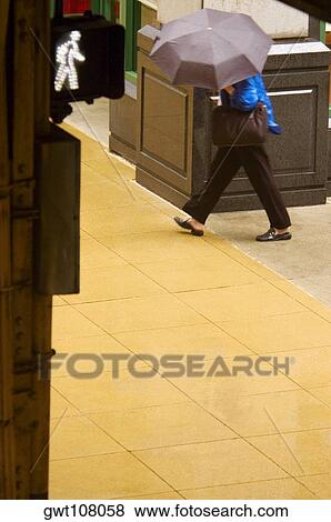 Side profile of a person walking with an umbrella, Chicago, Illinois, USA View Large Photo Image Stock Photo - Side profile of a person walking with an umbrella, Chicago, Illinois, USA. Fotosearch