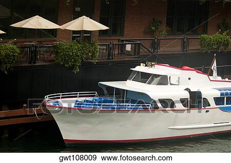 Tour boat moored in front of a restaurant, Chicago, Illinois, USA View Large Photo Image Stock Photo - Tour boat moored in front of a restaurant, Chicago, Illinois, USA. Fotosearch