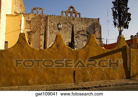 Stock Image - Arched wall in front of an old ruin, Mexico. Fotosearch