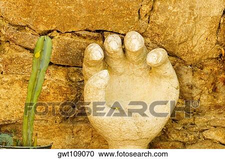 Stock Image - Close-up of a human hand carved on stone, Mexico. Fotosearch