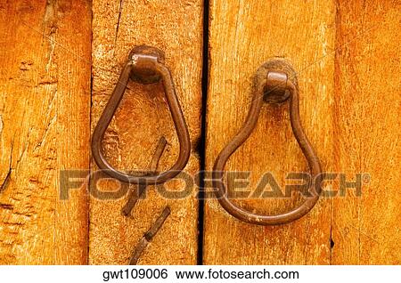 Close-up of a pair of doorknockers on a door View Large Photo Image Stock Photograph - Close-up of a pair of doorknockers on a door. Fotosearch