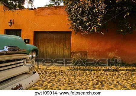 Picture - Close-up of a semi-truck parked in front of a house, Mexico. Fotosearch