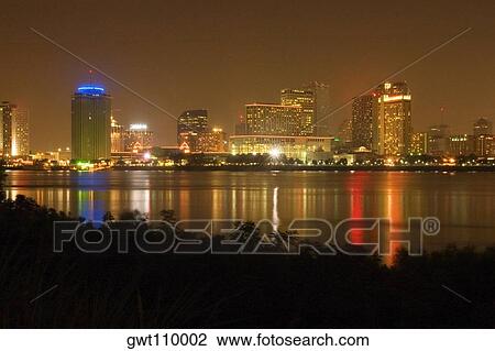 Stock Image - Buildings in a city lit up at night, New Orleans, Louisiana, USA. Fotosearch